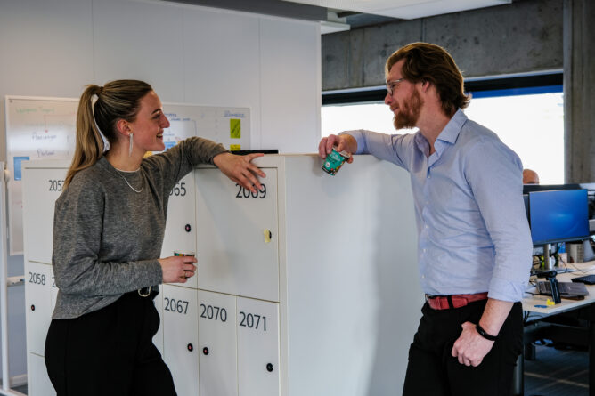 Medewerkers staan te praten bij een kast